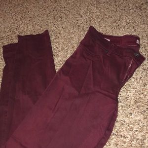 Maroon jeans with unique material.
